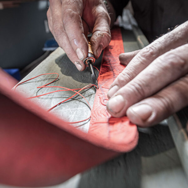 Cutting the leather at the belt edges with the edge cutter. From Neptune Jewels.