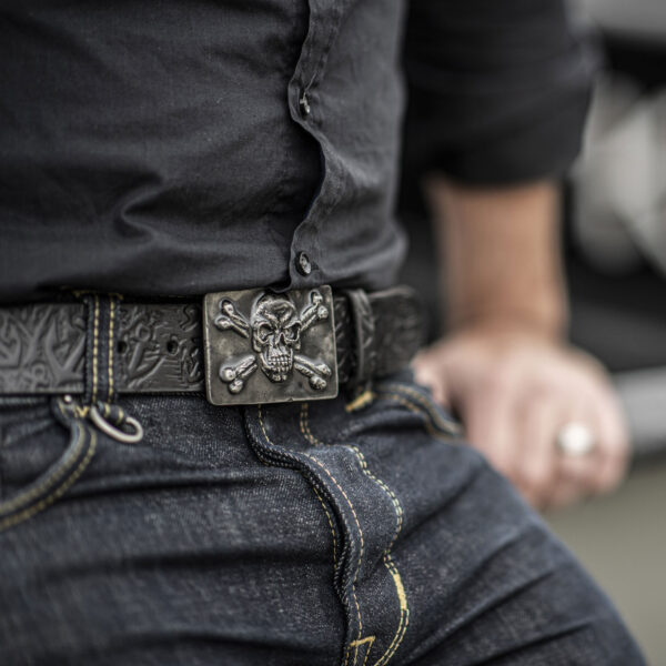 Skull belt buckle with hand-embossed anchor belt made by Neptune's jewelry, worn by sailors on deck.