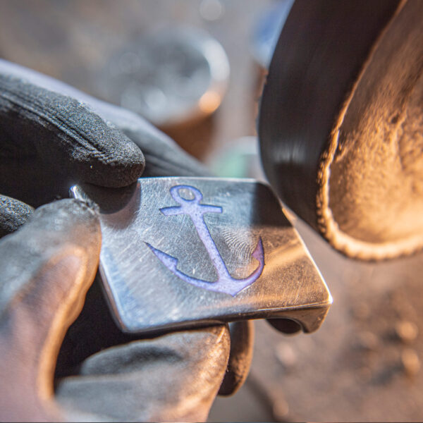 A look into the Neptune jewelry workshop: Polishing the anchor belt buckle with blue cast resin filling.