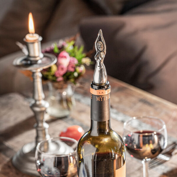 Flaschennixe bottle stopper from NeptunsSchmeide is used as a bottle stopper in a red wine bottle with glasses and candlelight.