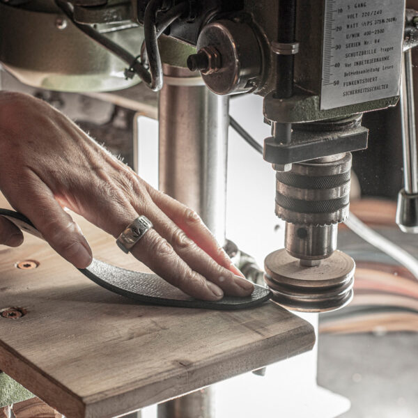 Jewels of Neptune, making a belt. Figure: Edges of a belt strap being ground and polished.