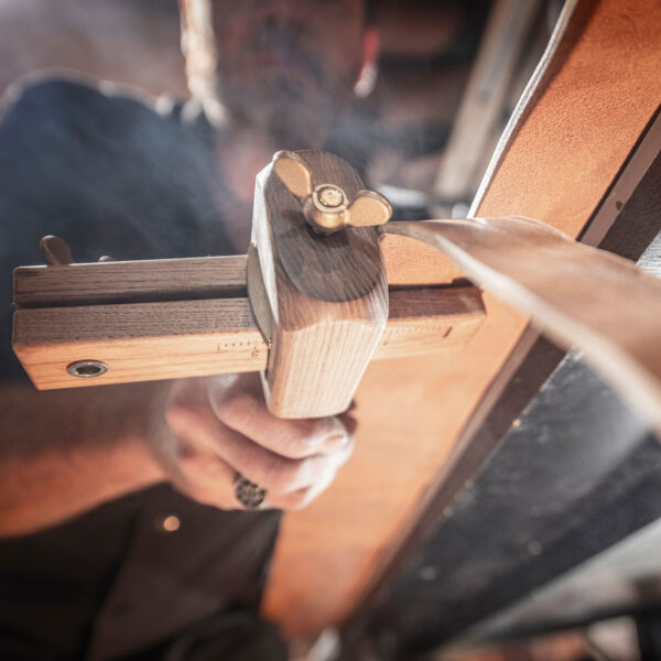 Simple interchangeable belt from Neptune jewelry. Figure: Leather strap being cut from the hide by hand.