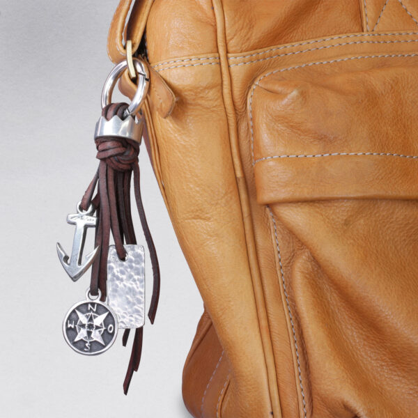 Gebamsel® pendant crown and compass, detail picture on leather case, by NeptunsSchmeiße. Bag or key ring with snap hook small.