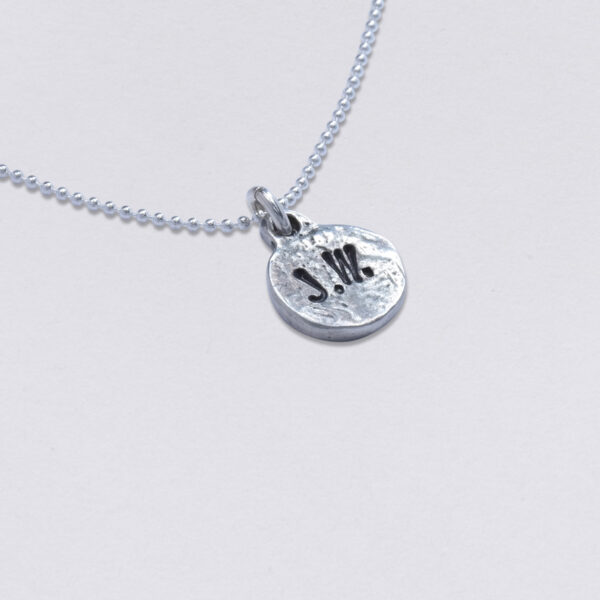 Necklace initials, round deepened pendant, 11 mm. Front with 2 embossings including set with ball chain, available in three lengths. Back side with desired embossing. detail view.