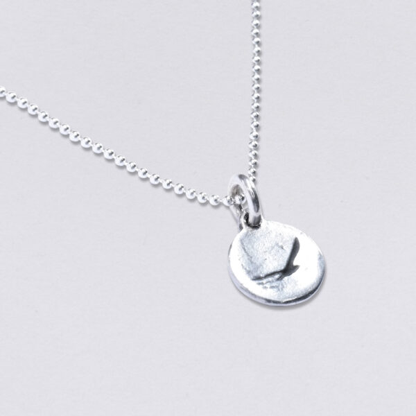 Necklace seagull pendant round deepened, 11 mm. Set with ball chain, available in three lengths. Front and back with desired embossing. detail view.