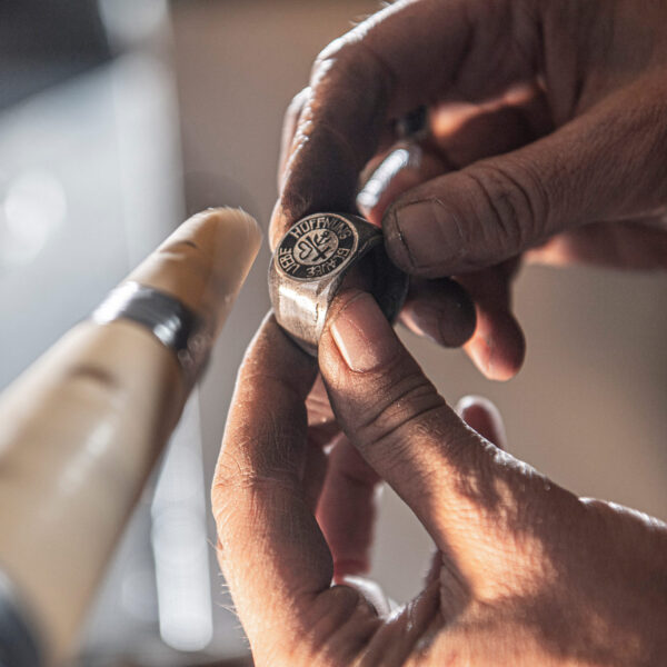 Faith Love Hope Signet ring being cut in the workshop. . Size approx. 16 x 25 mm, made of Neptune jewelry.