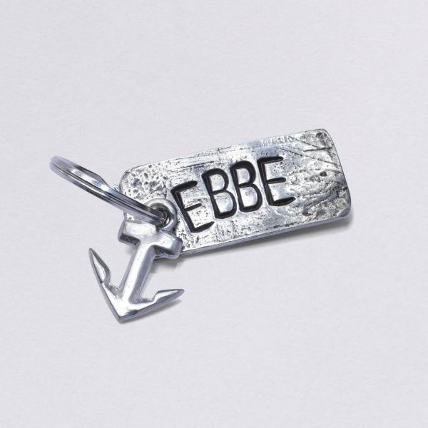 Schlüsselanhänger mit Prägung Ebbe mit kleinem Anker, Maße: ca. 2 x 4,5 cm, von Neptunsgeschmeide. Individualisierbar mit Wunschprägung.