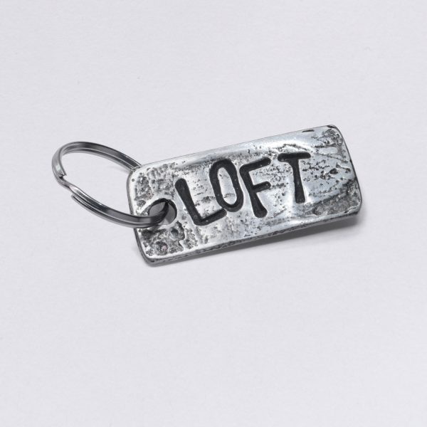 Key ring with Loft embossing, pewter with inclusions, dimensions: approx. 2 x 4,5 cm, from Neptune jewelry. Customizable with desired embossing.